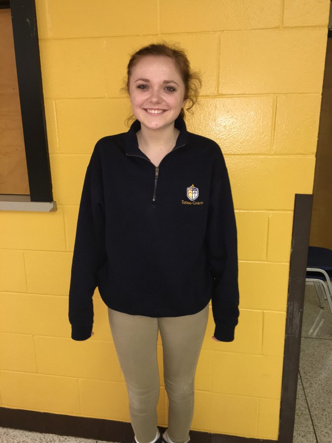 Junior Isabelle Jordan showing off the new quarter zip sweatshirt. 